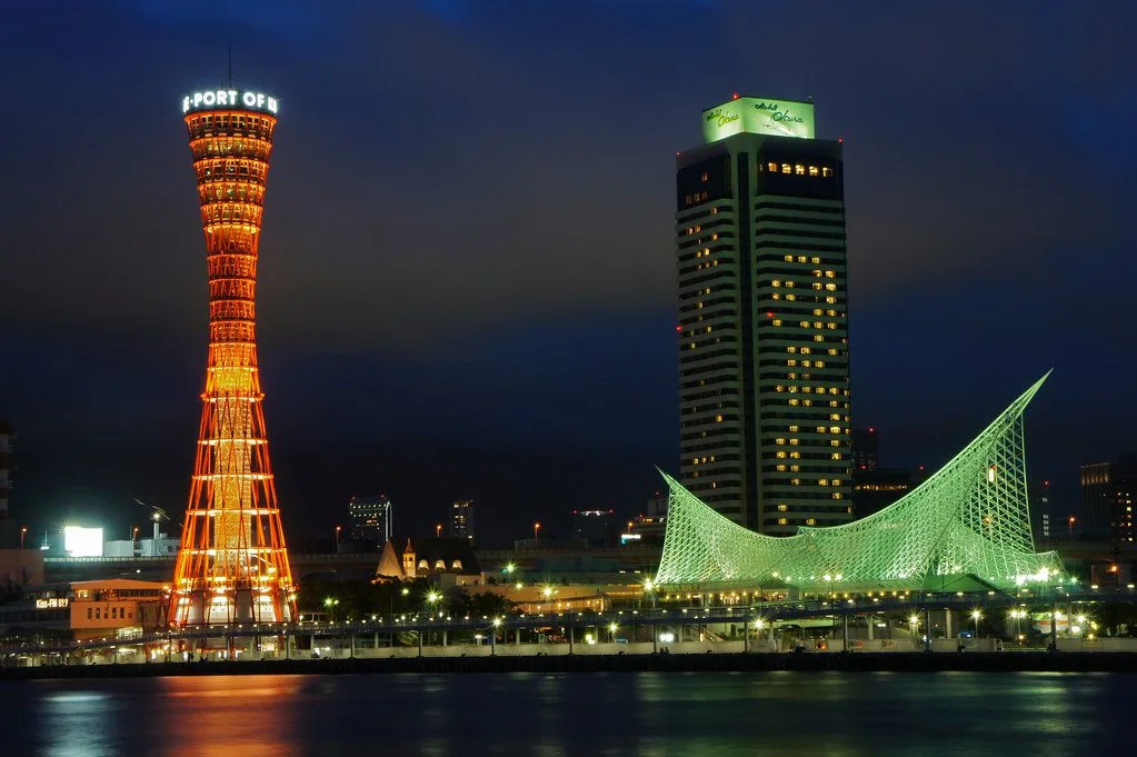 Kobe Port Tower glowing above the waterfront at night