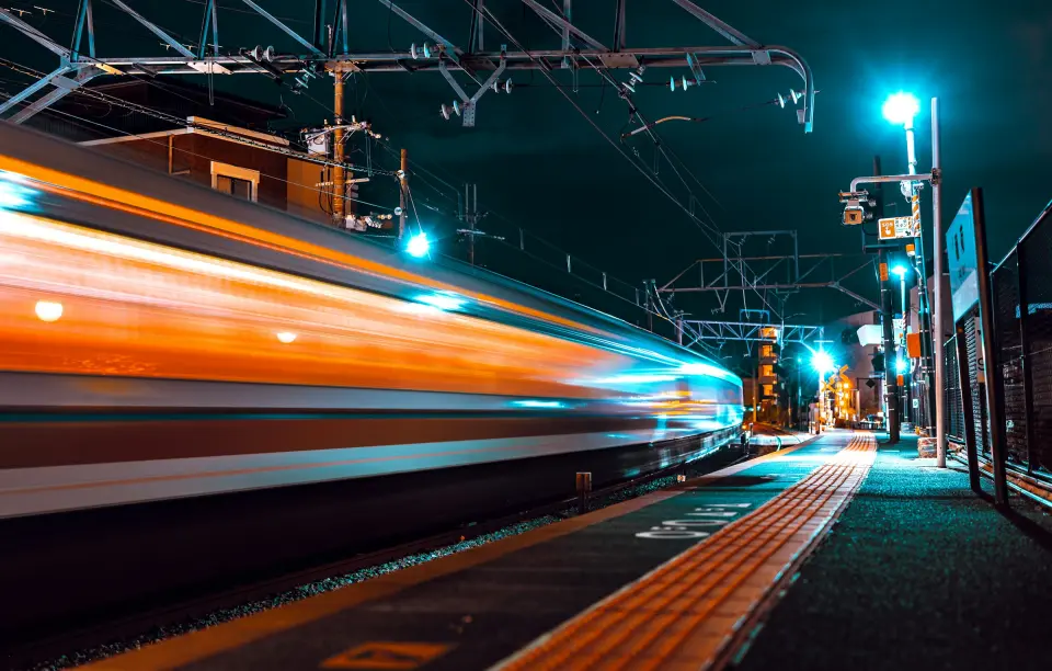 Night train crossing the illuminated city